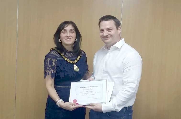 Deputy Mayor of Hillingdon presenting Blake Guyan the award